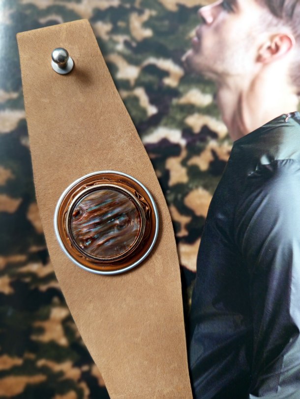 Bracelet Manchette (bras ou cheville) cuir véritable agrémenté d 'un élément de récupération . Cuir très souple, adaptable à la taille du poignet (6 trous) . Longueur totale de la manchette : 24.5cm